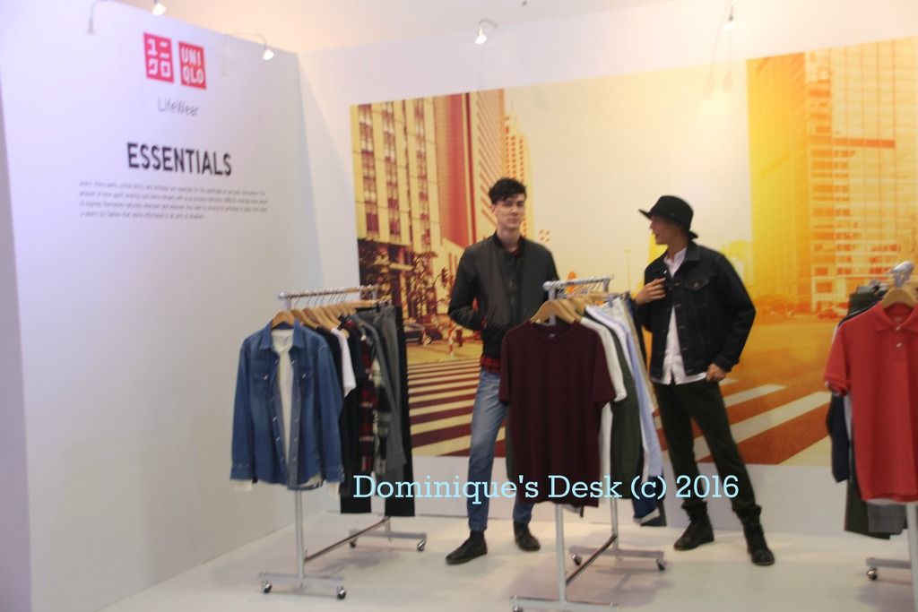 The models beside the clothes they were showcasing