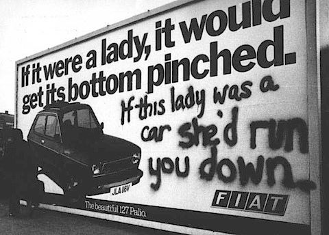 Advertisement of car that says If it were a lady it would get its bottom pinched.  Graffiti next to it reads: If this lady was a car she'd run you down