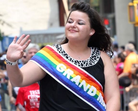 Constance wearing a rainbow sash