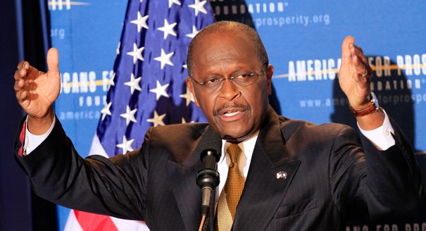 herman cain raises his arms while speaking