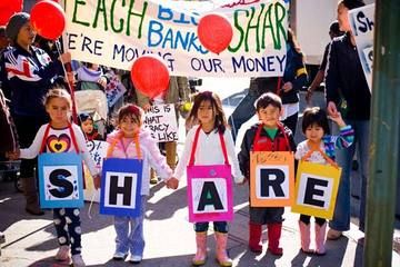 Kids spelling out SHARE at protest in Oakland