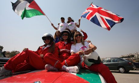 The Speed Sisters posing on a car