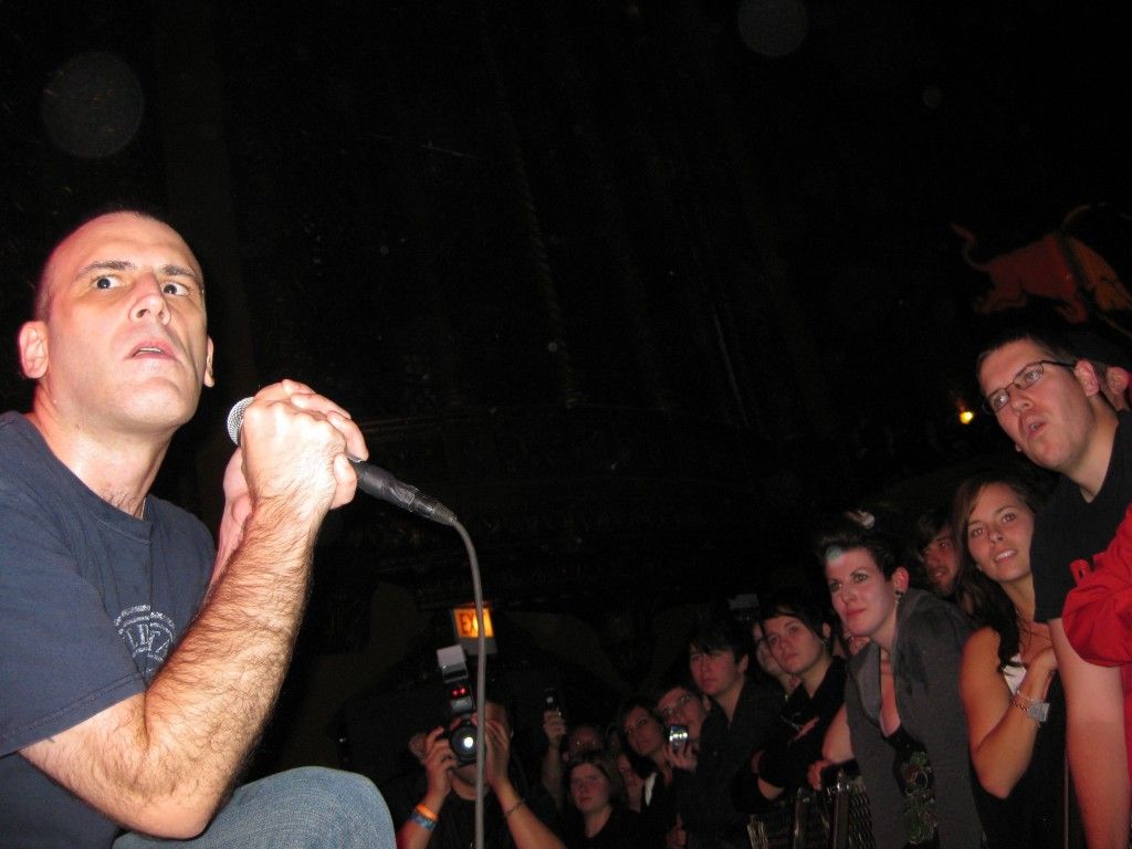 Ben Weasel (Foster) stands on stage in front of a crowd