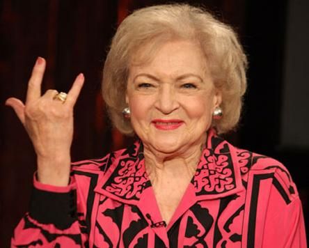 betty white making the RAWK sign with her hand