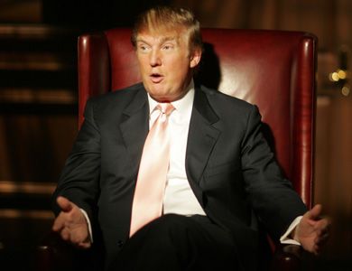 Donald Trump sitting in a chair wearing a suit and looking bewildered