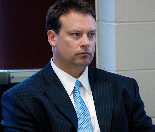 Photo of Heath Schuler, wearing blue suit and not smiling
