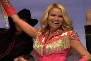 Kristin Chenoweth in a pink cowgirl costume singing on Glee