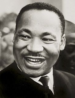 mrtin luther king jr smiles and looks to the side