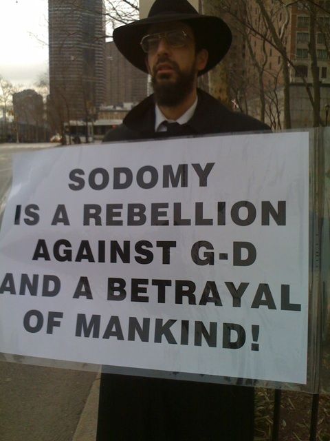 a man stands outside the building at last year's CSW holding a sign that reads sodomy is a rebellion against g'- and a betrayal of mankind