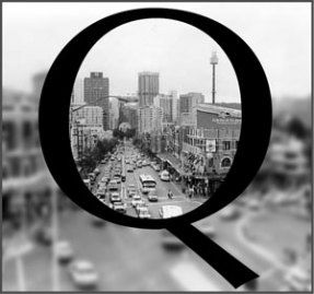 picture of a Q on top of a black and white city scene
