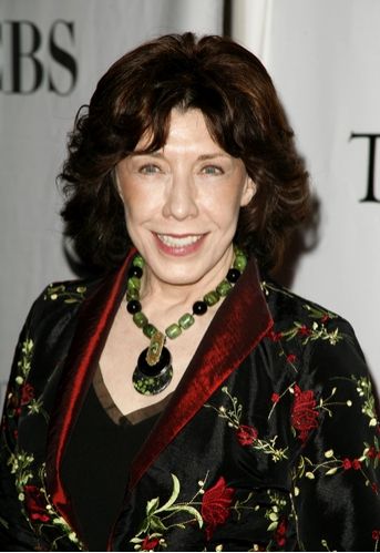 Photo of Lily Tomlin, smiling with green necklace